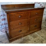 A 1920's elm and oak bank of haberdashery drawers with protective glass top Height 93.5cm x width