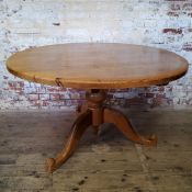 An early 20th century farmhouse pine dining / tavern table, bold turned support with carved shaped