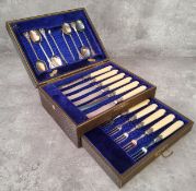 A cased silver plate high tea set for six comprising tea spoons, sugar nips, butter knifes & cake