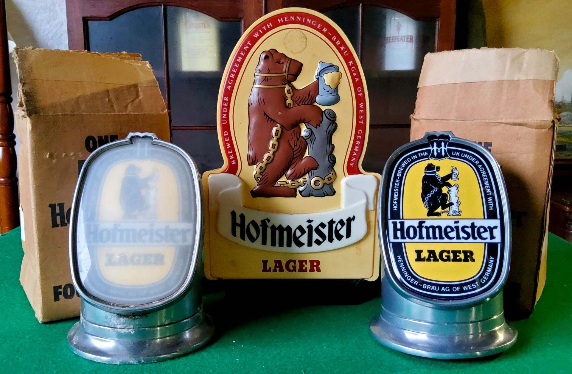 Two 1984 Hofmeister Lager mini font covers in original cardboard trade carton; a vintage plastic