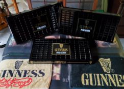 Three Guinness drip trays in mint condition; two bar towels and two rubber bar mats (7)