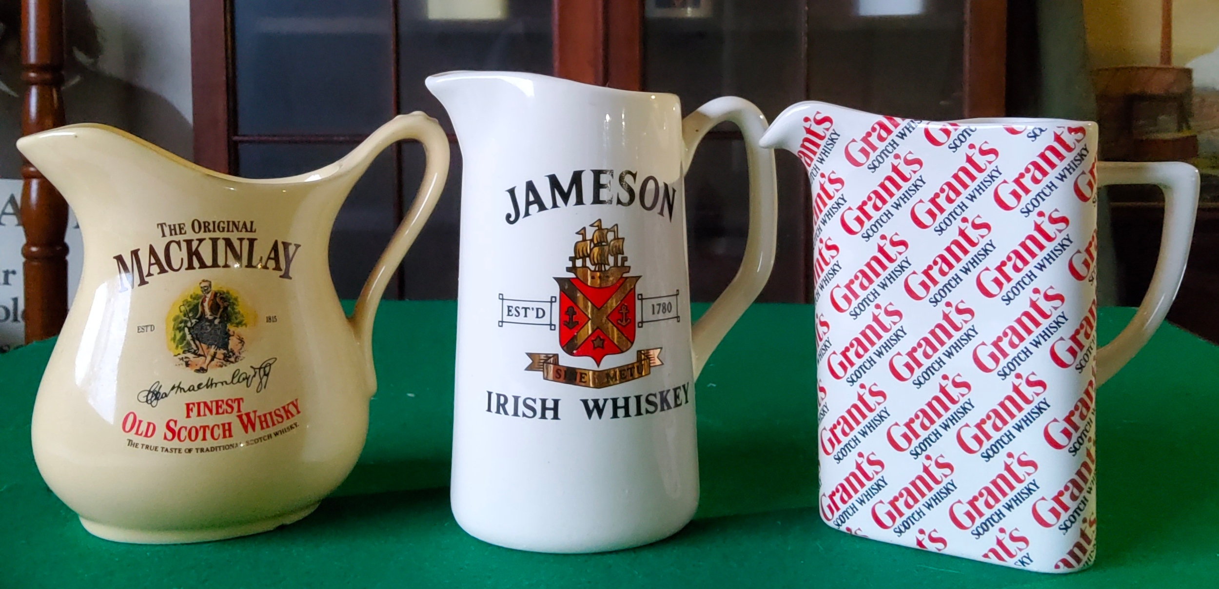 A Grant's Scotch Whisky water jug; Jamesons Irish Whiskey water jug and a Mackinlay Finest Old