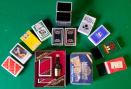 Advertisement - a collection of playing card decks of various brands including a Martell medallion
