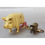 A Victorian novelty brass needlework tape measure, modelled as a pig; an early 20th century