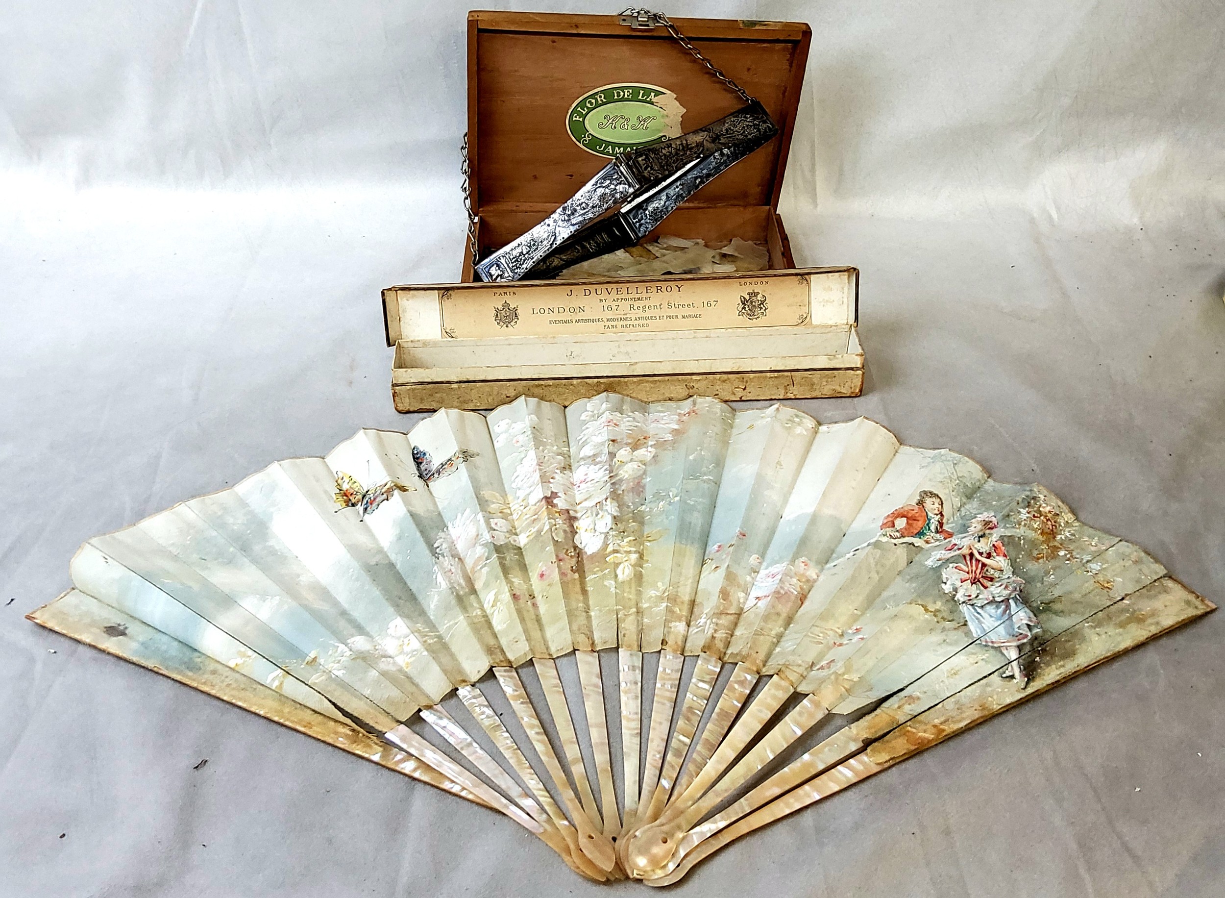 A 19th century French fan, hand painted on linen and ablone/mother of pearl fixtures for