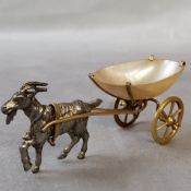 A 19th century novelty open salt, of a white metal goat pulling a mother-of-pearl yellow metal cart,