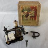 German possibly Muller or Casige tinplate sewing machine transferred printed with a bird in fruiting