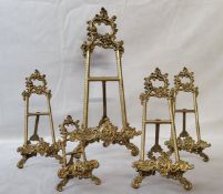 Five decorative Roccoco type brass table easels, various sizes, the largest measures 40cm high