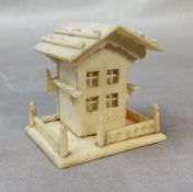 Sewing Interest - a 19th century Continental bone novelty thimble case, in the form of a house,