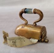 Sewing Interest - a novelty brass and banded agate tape measure in the form of an iron, 7cm wide.