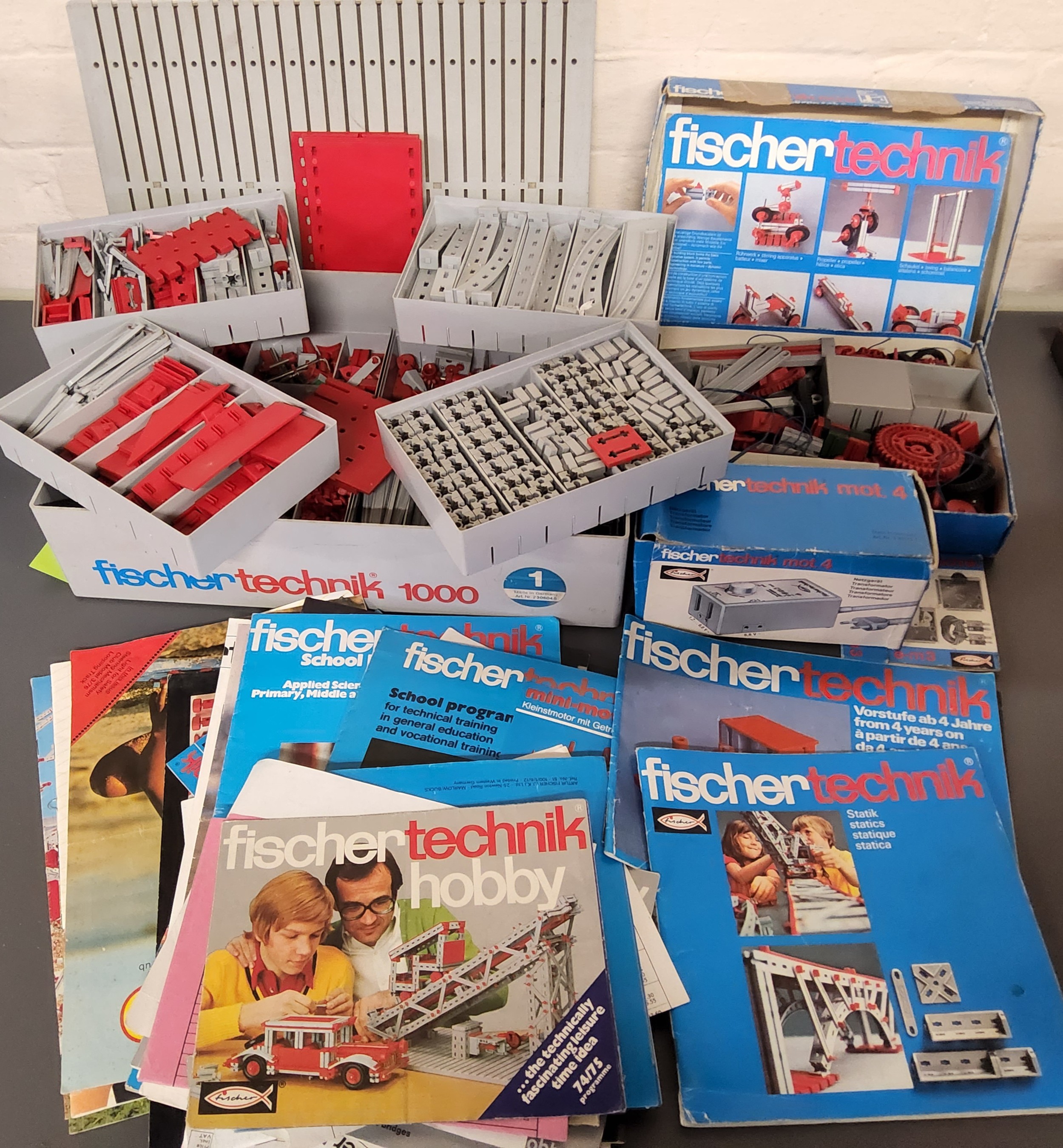 A retro Fischer Technic 1000 sorting box, fitted trays containing a quantity of single parts;