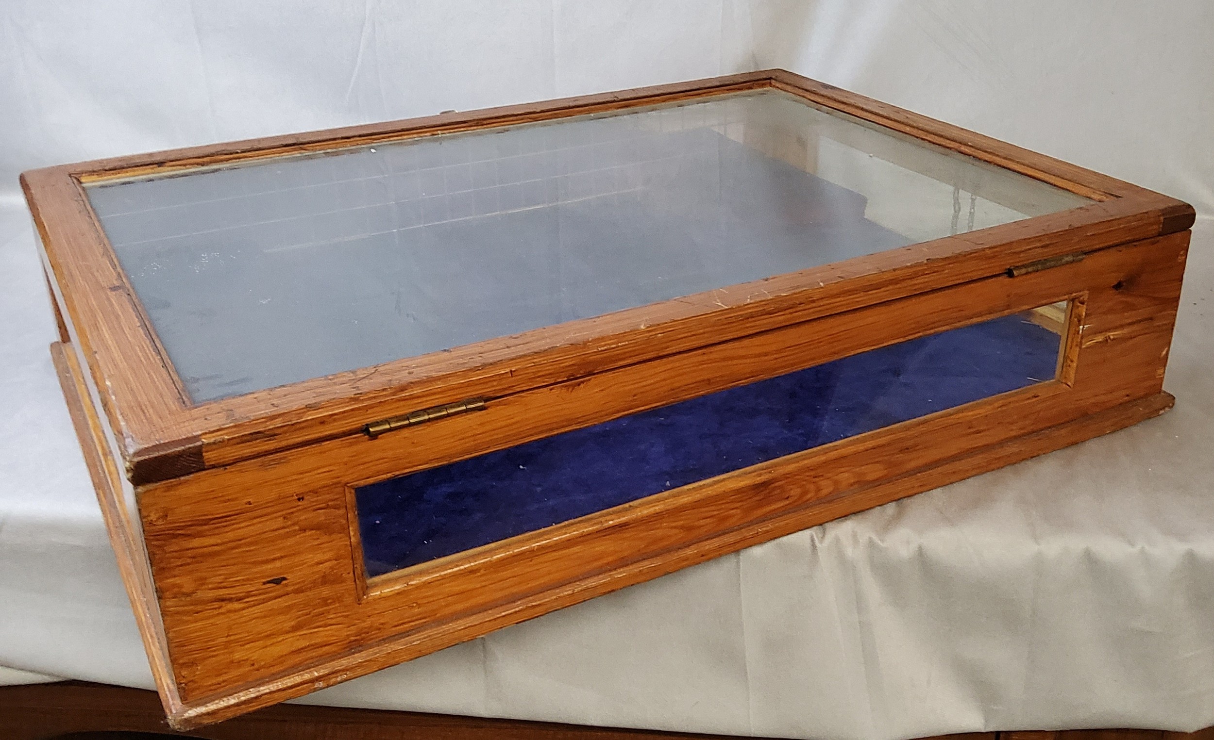 A large 20th century stained pine table top bijouterie cabinet, glass complete.  74cm wide x 52cm