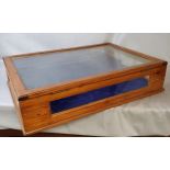 A large 20th century stained pine table top bijouterie cabinet, glass complete.  74cm wide x 52cm