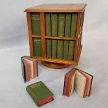 A 1904 revolving miniature bookcase, containing miniature editions of the work of William