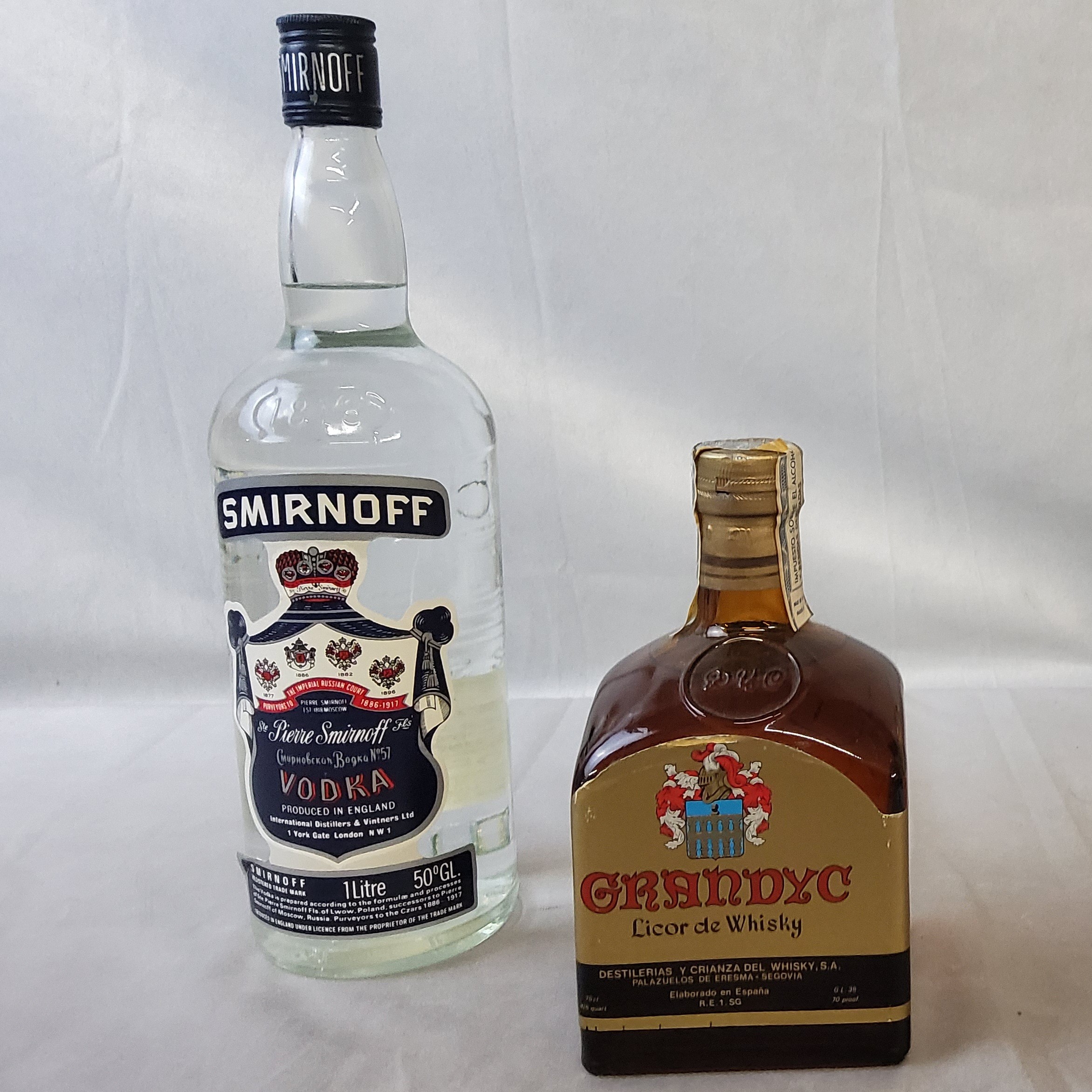 Smirnoff export vodka, 1 litre, sealed, 50% vol, post stickered Aug 85 ; Grandyc Licor de Whisky,