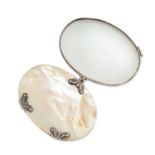 AN ANTIQUE MOTHER OF PEARL MAGNIFYING GLASS in silver, the oval body formed of two polished pieces