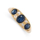 A SAPPHIRE AND DIAMOND DRESS RING in yellow gold, set with a trio of oval cut blue sapphires,