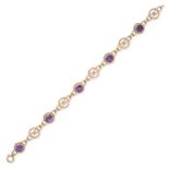 A VINTAGE AMETHYST BRACELET in yellow gold, set with five round cut amethyst, punctuated by Celtic