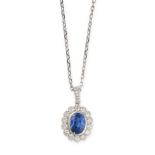 A SAPPHIRE AND DIAMOND PENDANT AND CHAIN in 18ct white gold, set with an oval cut blue sapphire of