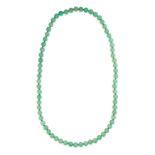 A GREEN HARDSTONE BEAD NECKLACE formed of a single row of sixty-eight polished green hardstone beads
