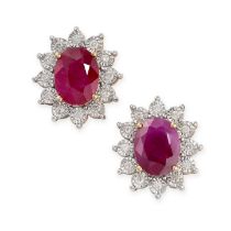 A PAIR OF RUBY AND DIAMOND STUD EARRINGS set with oval cut rubies, both totalling 3.85 carats, in