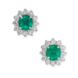 A PAIR OF EMERALD AND DIAMOND STUD EARRINGS each set with a cushion cut emerald, in a cluster of