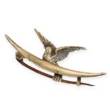 AN ANTIQUE CRESCENT MOON DOVE BROOCH in 15ct yellow gold, designed to depict a dove perched within a
