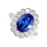 A TANZANITE AND DIAMOND CLUSTER RING in 18ct white gold, set with an oval-cut tanzanite of 4.55
