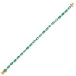 AN EMERALD AND DIAMOND LINE BRACELET set with alternating oval-cut emeralds and clusters of four