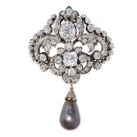 A FINE NATURAL BLACK PEARL AND DIAMOND BROOCH in yellow gold and silver, the scrolling body set with