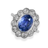 A CEYLON NO HEAT SAPPHIRE AND DIAMOND CLUSTER RING set with an oval cut sapphire of 3.39 carats in a