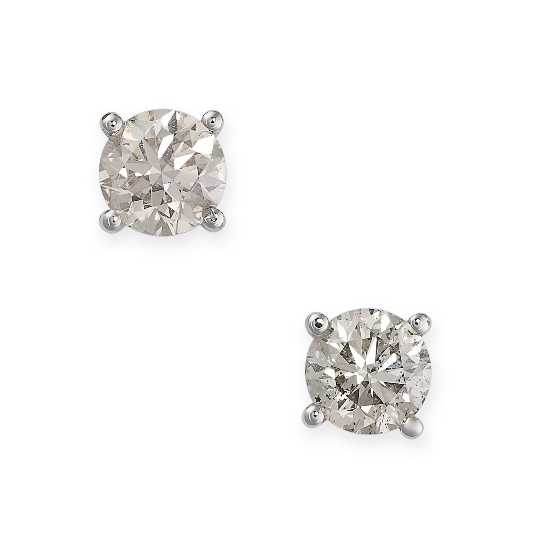 A PAIR OF DIAMOND STUD EARRINGS each set with a round cut diamond, both totalling 1.18 carats,