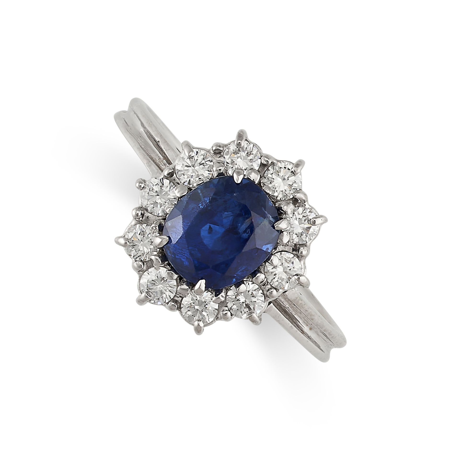 AN UNHEATED SAPPHIRE AND DIAMOND RING set with an oval cut sapphire of 1.43 carats in a cluster of