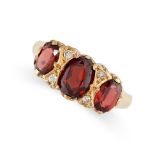 A GARNET AND DIAMOND DRESS RING in 18ct yellow gold, set with a trio of graduated oval cut