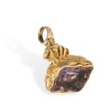 AN ANTIQUE AMETHYST FOB SEAL PENDANT of scrolling fluted design, set with a piece of faceted