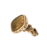 AN ANTIQUE CITRINE INTAGLIO FOB SEAL PENDANT of scrolling foliate design, set with a carved