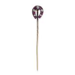 AN ANTIQUE RUBY AND DIAMOND HORSESHOE PIN in yellow gold and silver, set with alternating cushion