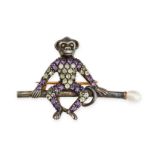 A GEMSET MONKEY BROOCH designed as a monkey sat on a bar, set with round cut diamonds, amethysts and