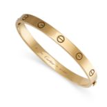 CARTIER, A LOVE BANGLE in 18ct yellow gold, the oval bangle punctuated with screw head motifs,