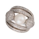 A PEARL AND DIAMOND BOMBE RING set with a central pearl of 9.3mm between two spheres pave set with