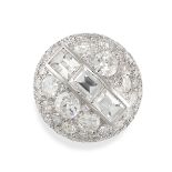 A DIAMOND BOMBE RING in platinum, the circular domed face set with a row of three baguette cut