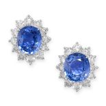 A PAIR OF SAPPHIRE AND DIAMOND CLUSTER EARRINGS in 18ct white gold, each set with an oval cut