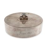 GEORG JENSEN, AN OVAL SILVER JEWELLERY BOX in silver, the hinged lid with mirror and floral knop,