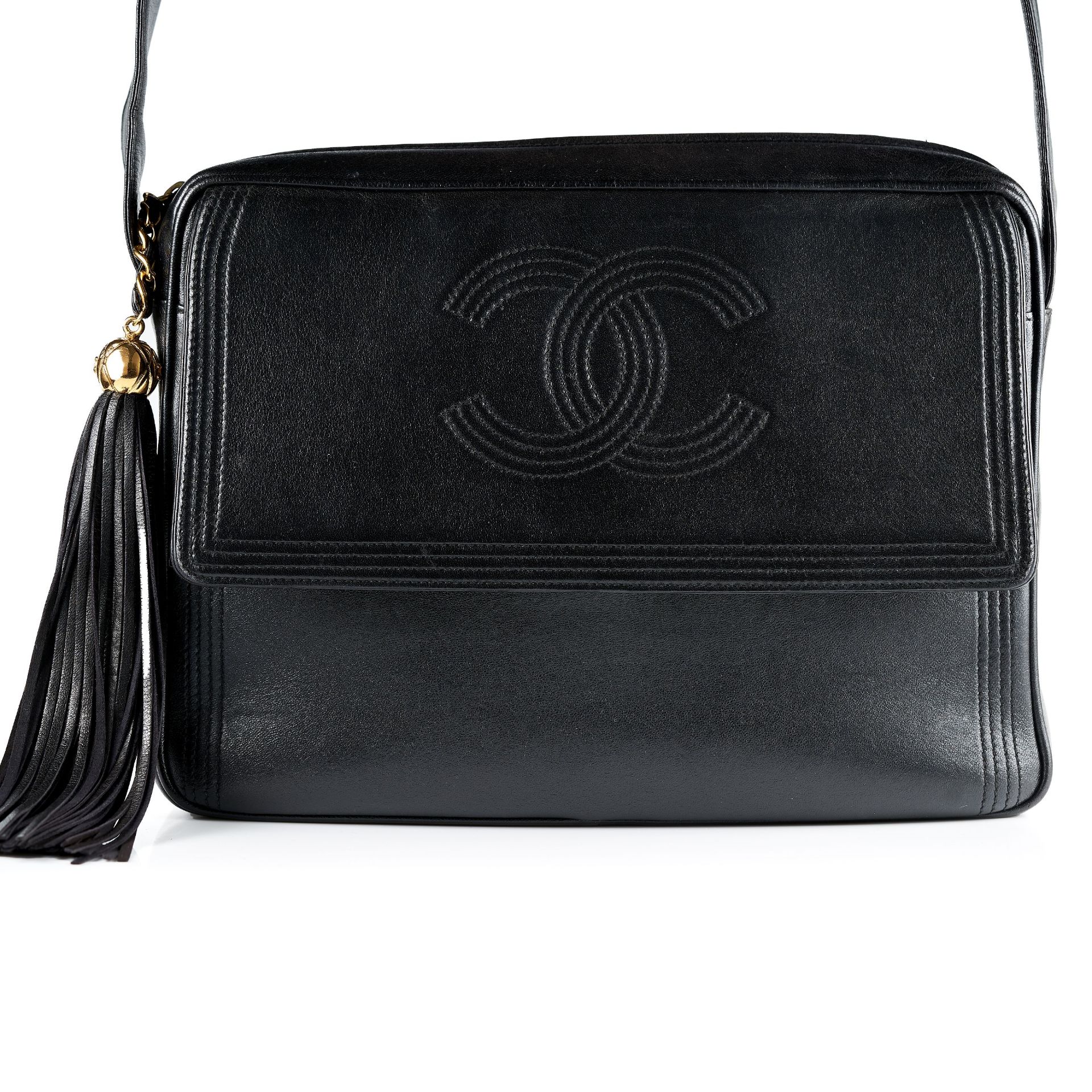 CHANEL, A VINTAGE UNISEX SHOULDER BAG black leather strap, gold tone hardware, later black tassel,