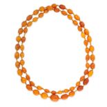 AN ANTIQUE AMBER BEAD NECKLACE comprising a single row of graduated polished amber beads ranging