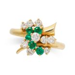 AN EMERALD AND DIAMOND RING in 18ct yellow gold, in foliate design, set with round cut emeralds