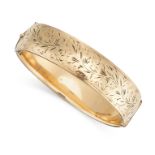 A VINTAGE BANGLE the hinged body, decorated with engraved foliate designs, stamped 9ct metal core,