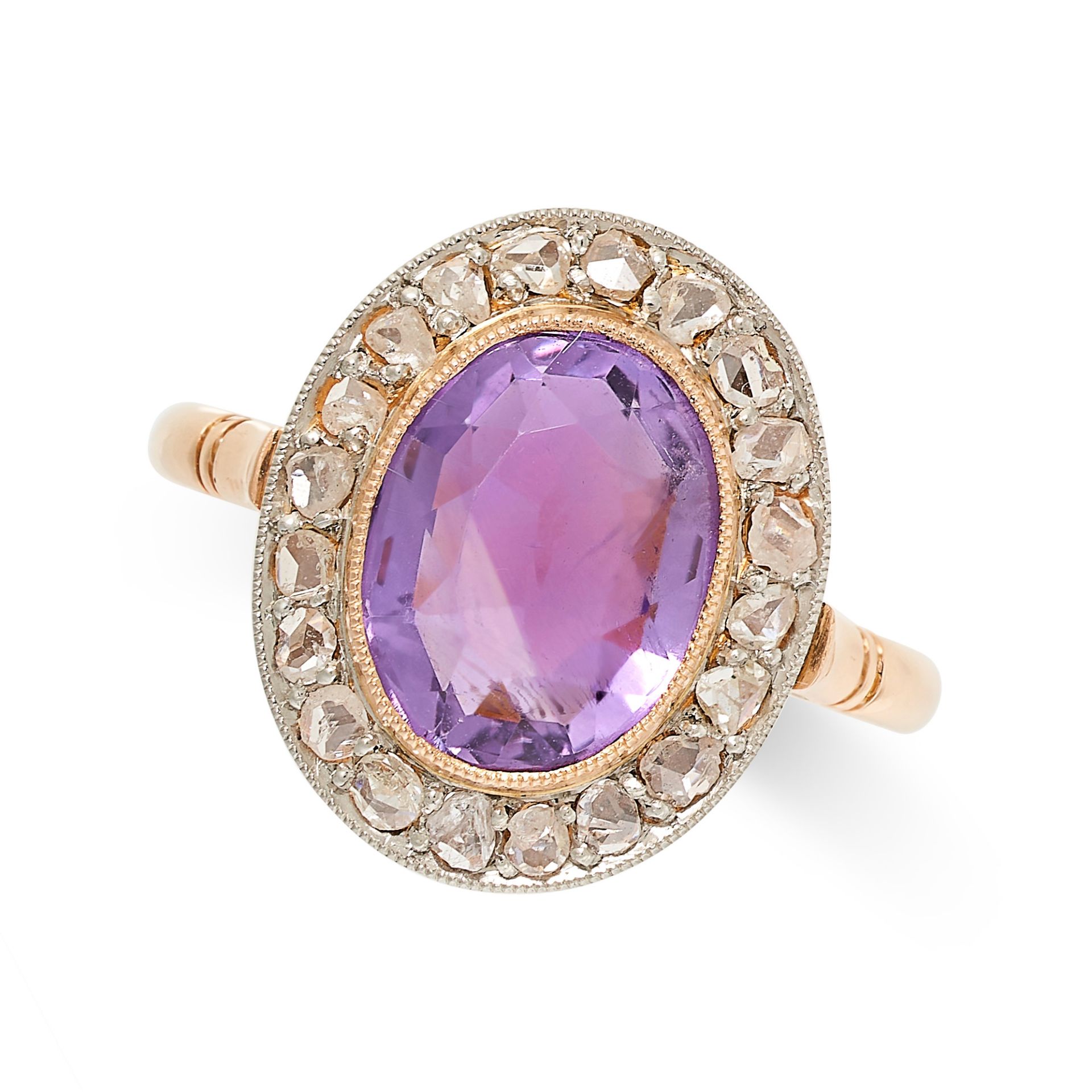 A VINTAGE AMETHYST AND DIAMOND CLUSTER RING in yellow gold, set with an oval cut amethyst in a