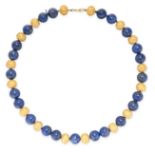 A LAPIS LAZULI BEAD NECKLACE in yellow gold, comprising a single row of twenty-three polished