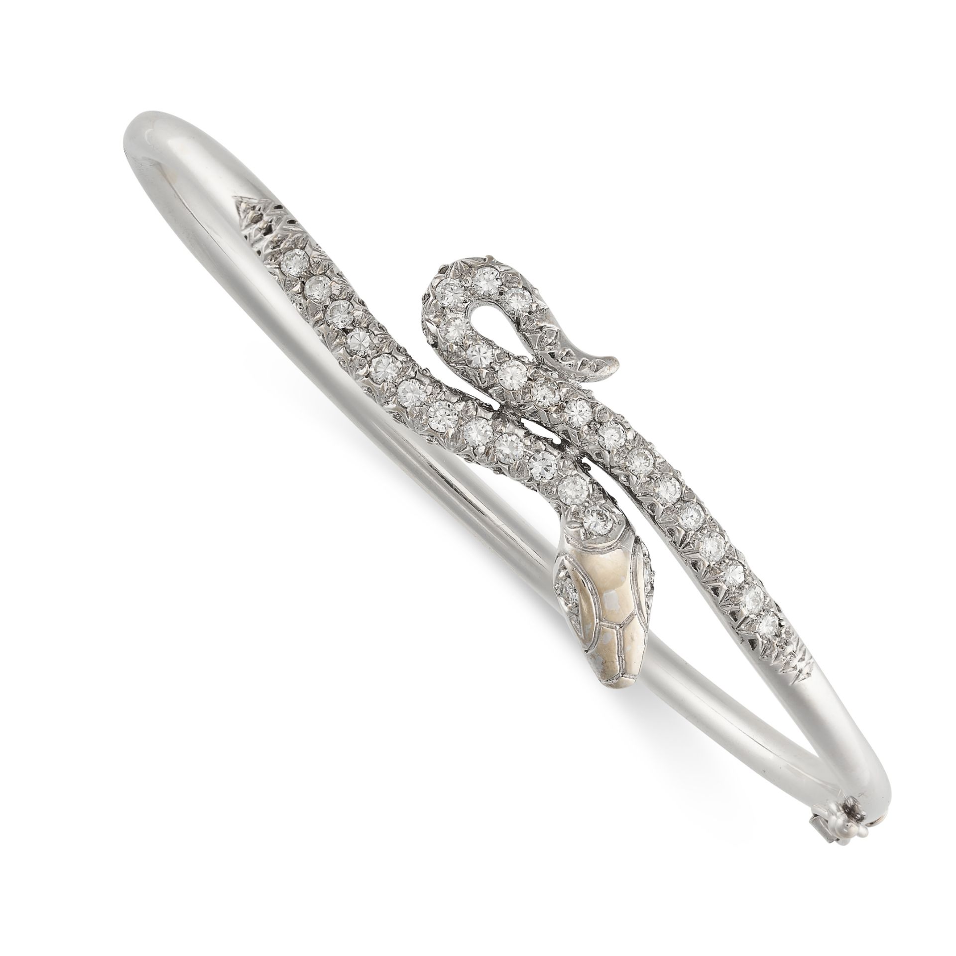 A DIAMOND SNAKE BANGLE designed as a coiled snake, set with round brilliant cut diamonds, stamped